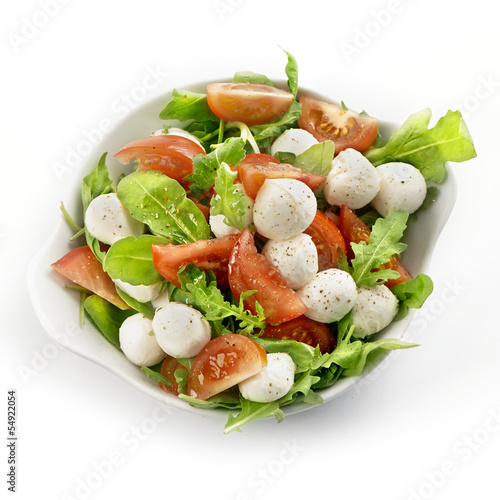 Photo: healthy fresh rucola salad with mozarella and tomato slices healthy fresh rucola salad with mozarella and tomato slices