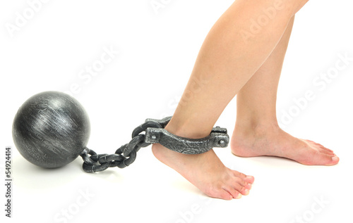 Photo: Legs in heavy iron shackles isolated on white Legs in heavy iron shackles isolated on white
