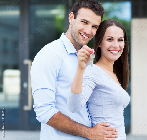 Photo: Couple showing their new house keys Couple showing their new house keys