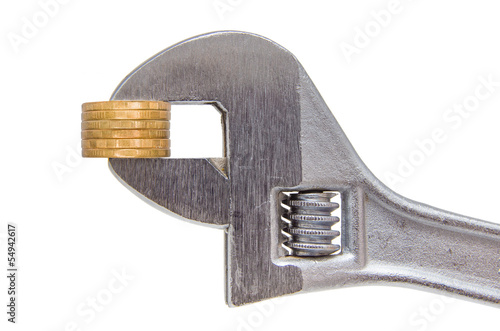 Photo: Golden coins and wrench isolated on white background Golden coins and wrench isolated on white background