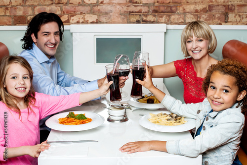Photo: Family raising their glasses before eating Family raising their glasses before eating