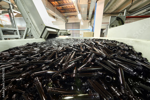 Photo: Big pile of small brown blanks to create plastic beer bottles Big pile of small brown blanks to create plastic beer bottles