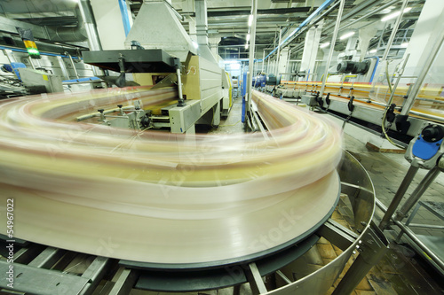 Photo: Bottles go on conveyor in factory Bottles go on conveyor in factory