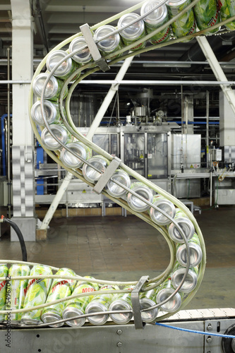 Photo: Cans of mojitos on S-shaped conveyor Cans of mojitos on S-shaped conveyor