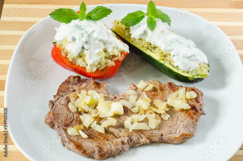 Photo: Beef steak with fried onion and stuffed vegetables Beef steak with fried onion and stuffed vegetables