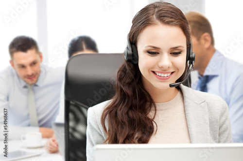Photo: helpline operator with headphones in call centre helpline operator with headphones in call centre