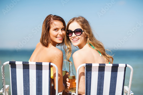 Photo: girls with drinks on the beach chairs girls with drinks on the beach chairs