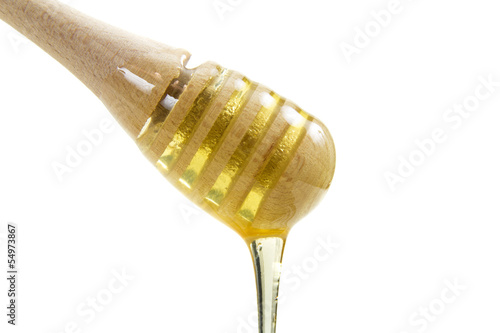 Photo: Honey dripping from wooden stick Honey dripping from wooden stick