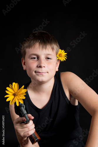 Photo: teenager with a gun and flowers teenager with a gun and flowers