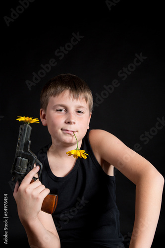 Photo: teenager with a gun and flowers teenager with a gun and flowers