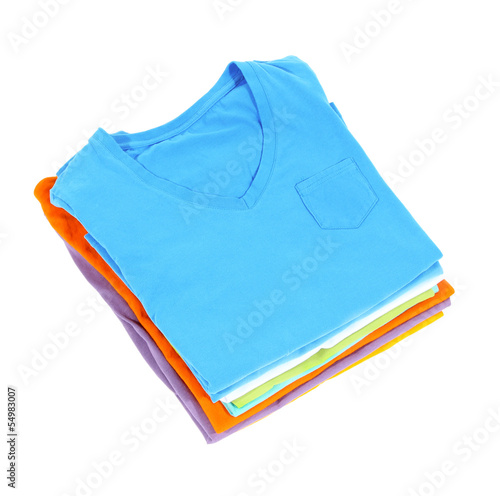 Photo: Neatly folded shirts isolated on white Neatly folded shirts isolated on white