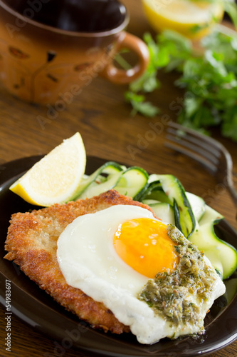Photo: Wiener schnitzel with fried egg and capers. Wiener schnitzel with fried egg and capers.