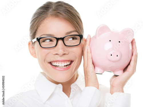 Photo: Glasses woman saving on eyewear showing piggy bank Glasses woman saving on eyewear showing piggy bank