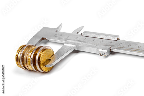 Photo: caliper and stack of coins isolated on white background caliper and stack of coins isolated on white background