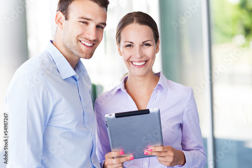 Photo: Business colleagues with digital tablet Business colleagues with digital tablet