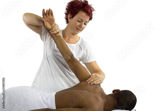 Photo: young female therapist helping young male patient young female therapist helping young male patient