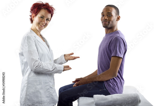 Photo: young female therapist consulting male client about posture young female therapist consulting male client about posture