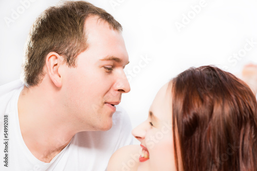 Photo: Young man and woman lying together in bed Young man and woman lying together in bed