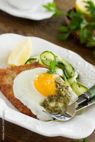 Photo: Wiener schnitzel with fried egg and capers. Wiener schnitzel with fried egg and capers.