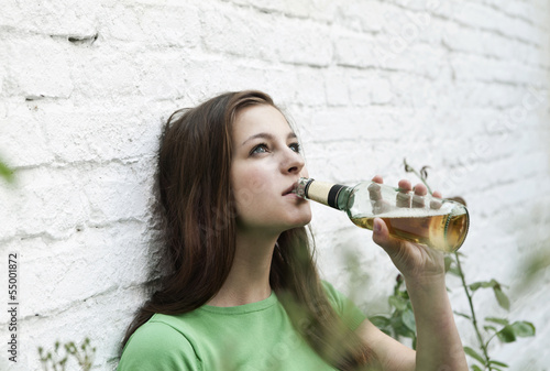 Photo: Deutschland, Berlin, Junge Frau trinkt Bier aus Bierflasche Deutschland, Berlin, Junge Frau trinkt Bier aus Bierflasche