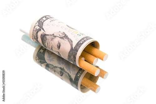 Photo: money and cigarettes on a white background with reflection money and cigarettes on a white background with reflection