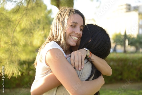 Photo: lesbian couple hugging lesbian couple hugging