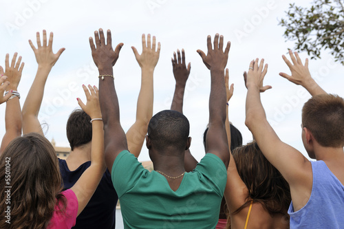 Photo: Diverse group raising hands Diverse group raising hands