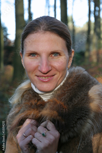 Photo: Portrait of young woman in fur coat in autumn or winter Portrait of young woman in fur coat in autumn or winter