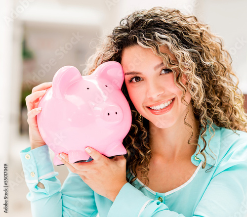 Photo: Happy woman with a piggybank Happy woman with a piggybank