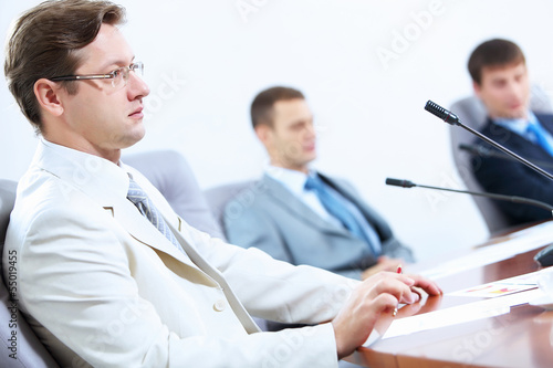 Photo: Three businesspeople at meeting Three businesspeople at meeting