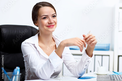 Photo: Young businesswoman in the office Young businesswoman in the office