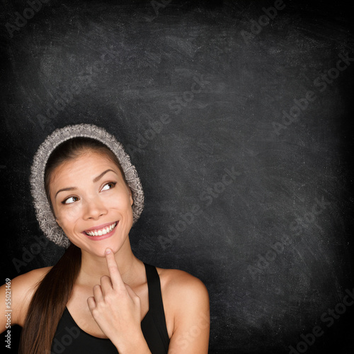 Photo: Thinking woman by blackboard Thinking woman by blackboard