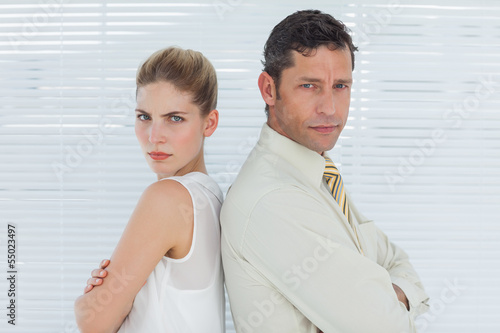 Photo: Angry business team posing back to back Angry business team posing back to back