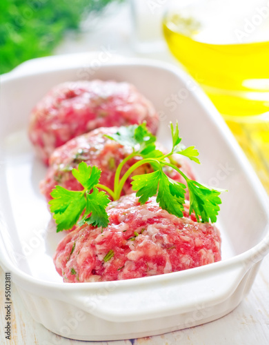 Photo: Raw meat balls in the white bowl Raw meat balls in the white bowl