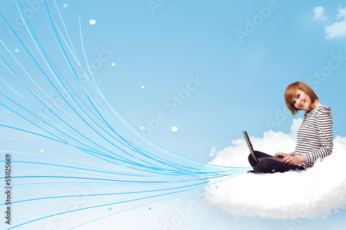Photo: Young woman sitting in cloud with laptop Young woman sitting in cloud with laptop