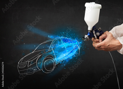 Photo: Worker with airbrush gun painting hand drawn car lines Worker with airbrush gun painting hand drawn car lines