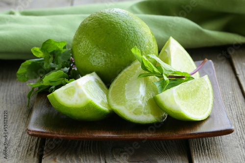Photo: Fresh limes with green mint - chopped and whole Fresh limes with green mint - chopped and whole
