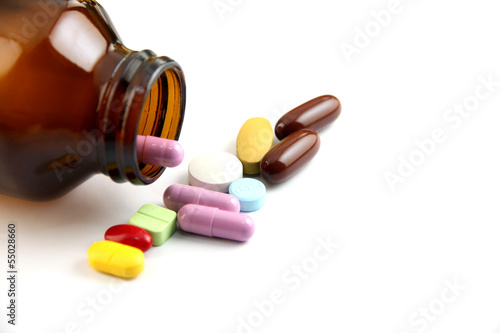 Photo: Pill of many color Beside the bottle. Pill of many color Beside the bottle.