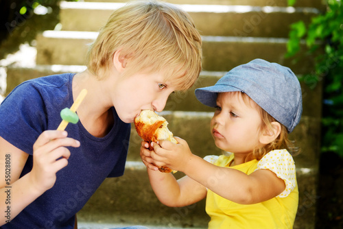 Photo: sister feeding brother sister feeding brother