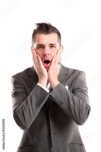 Photo: Portrait of young man with shocked facial expression Portrait of young man with shocked facial expression