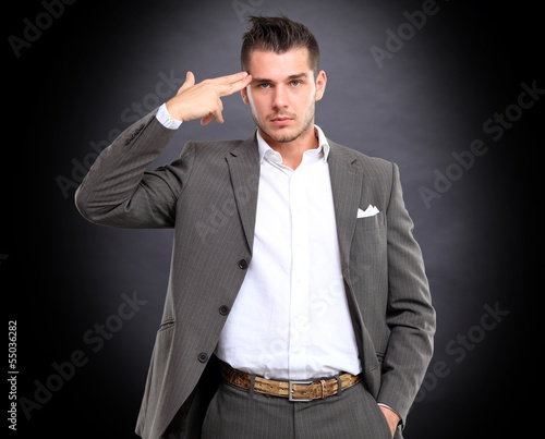 Photo: Portrait of elegant businessman touching his temple Portrait of elegant businessman touching his temple