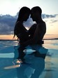 couple at dusk in water couple at dusk in water
