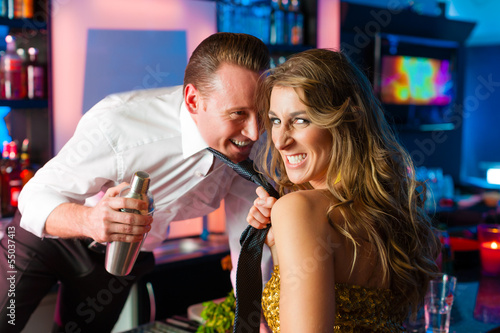 Photo: Woman dragging barkeeper in club or bar Woman dragging barkeeper in club or bar