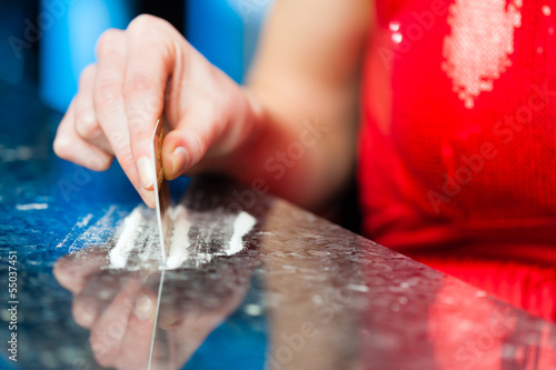 Photo: Young woman snorting cocaine in club or bar Young woman snorting cocaine in club or bar