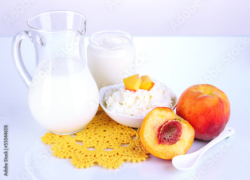 Photo: Fresh dairy products with peaches isolated on white Fresh dairy products with peaches isolated on white