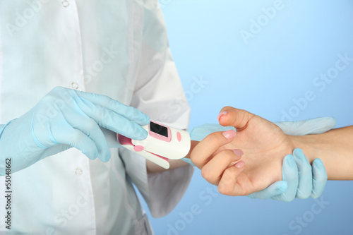 Photo: Doctor measuring pulse rate and oxygen levels, Doctor measuring pulse rate and oxygen levels,