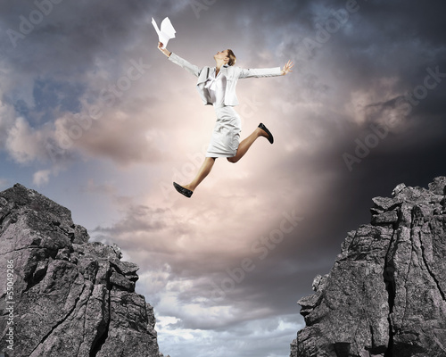 Photo: Young businesswoman jumping Young businesswoman jumping