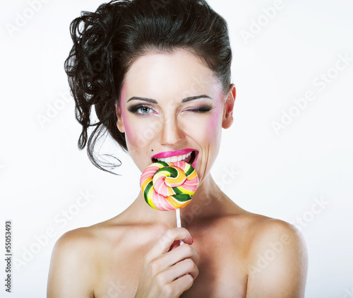 Photo: Coquette. Funny Quaint Brunette with Colorful Lollipop Coquette. Funny Quaint Brunette with Colorful Lollipop