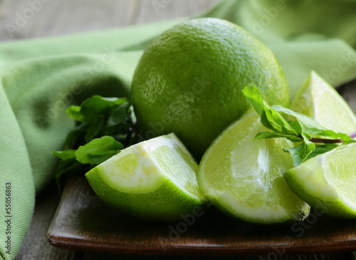 Photo: Fresh limes with green mint - chopped and whole Fresh limes with green mint - chopped and whole