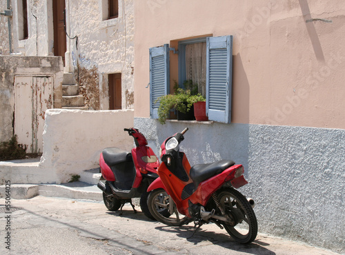 Photo: Scooters and Blue Greek Window Shutters Scooters and Blue Greek Window Shutters